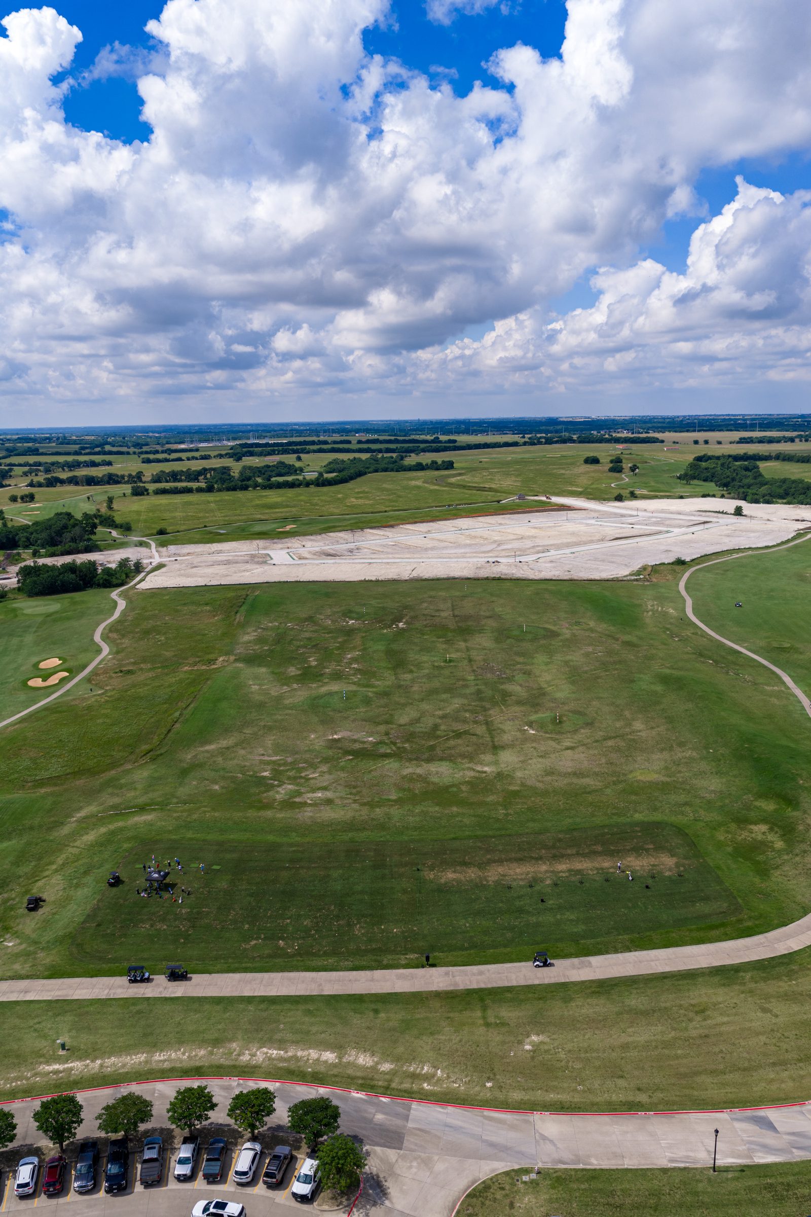 Aerial view down a fairway toward new homesites at The Bridges