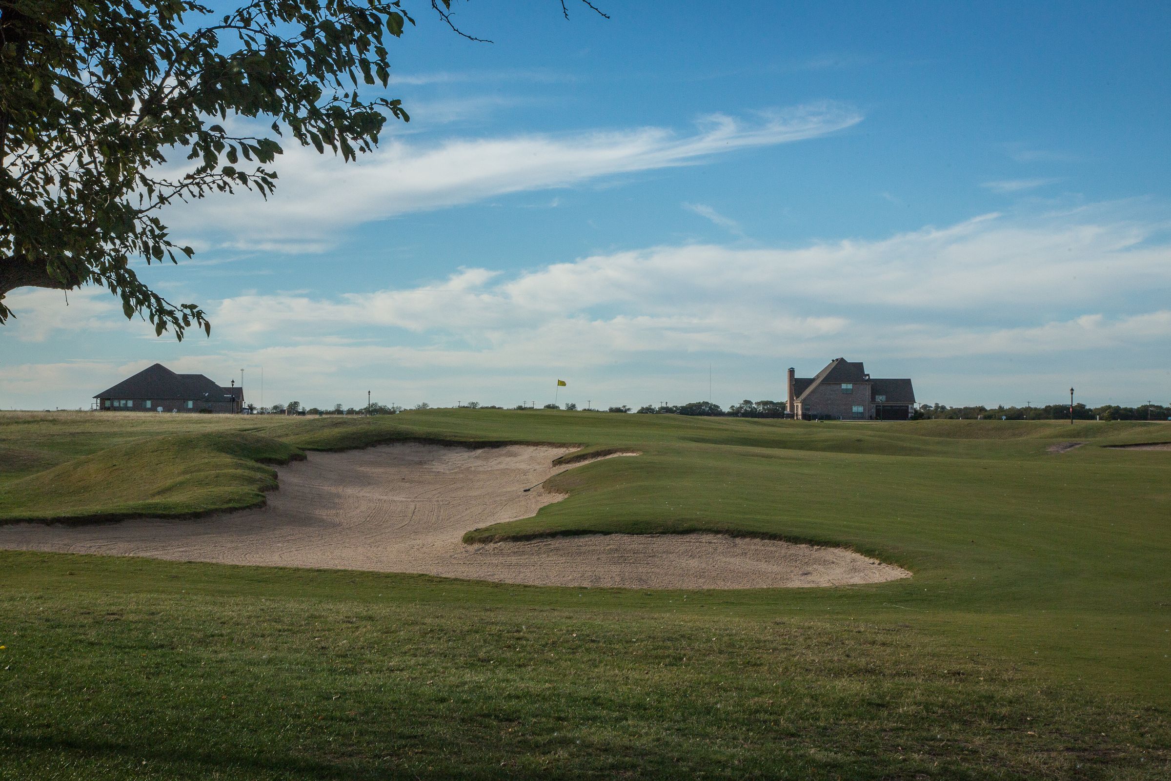 Custom homes set along the golf course and bunkers at The Bridges