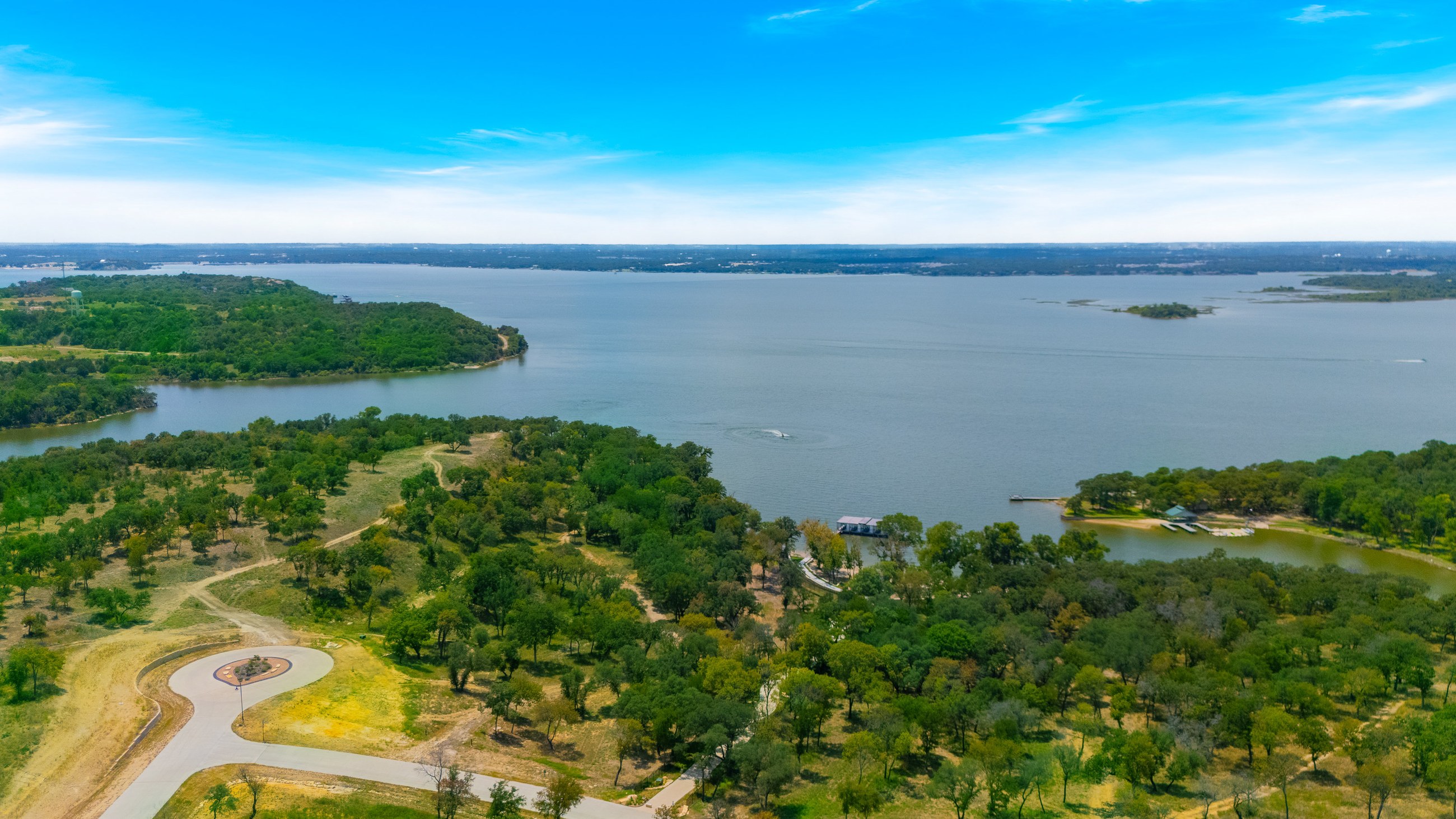 Aerial view of a homesite overlooking a lake and open Texas landscape